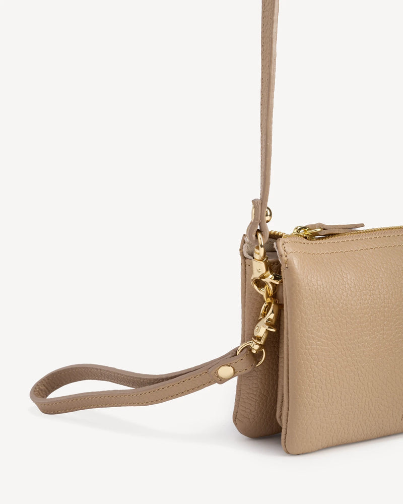 Pebbled-leather wristlet folded with wrist strap and gold zipper pull. The 3-in-1 Wristlet Biscotti Pebble.