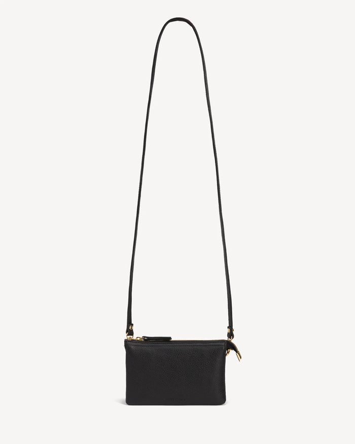 Front view of the pebbled-leather wristlet with a long crossbody strap laid flat. The 3-in-1 Wristlet Black.