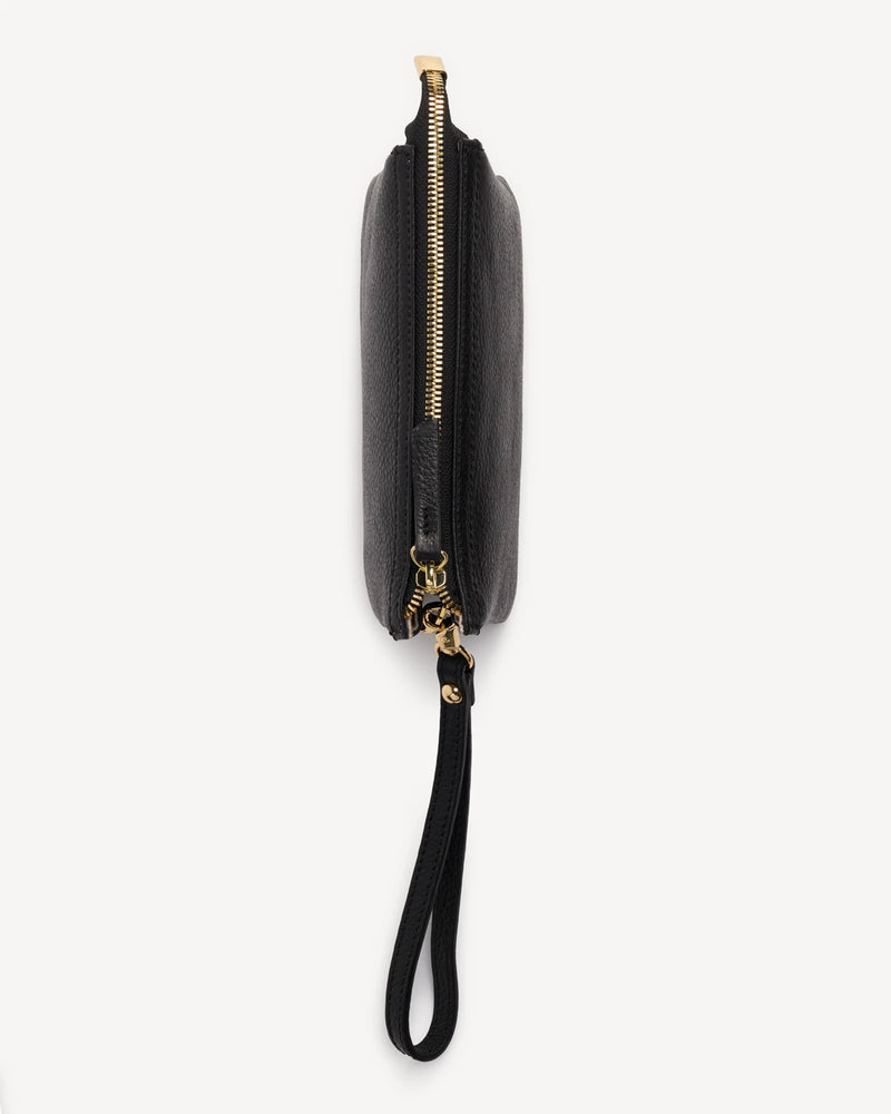 Side profile of the pebbled-leather wristlet showing zipper trim. The 3-in-1 Wristlet Black.