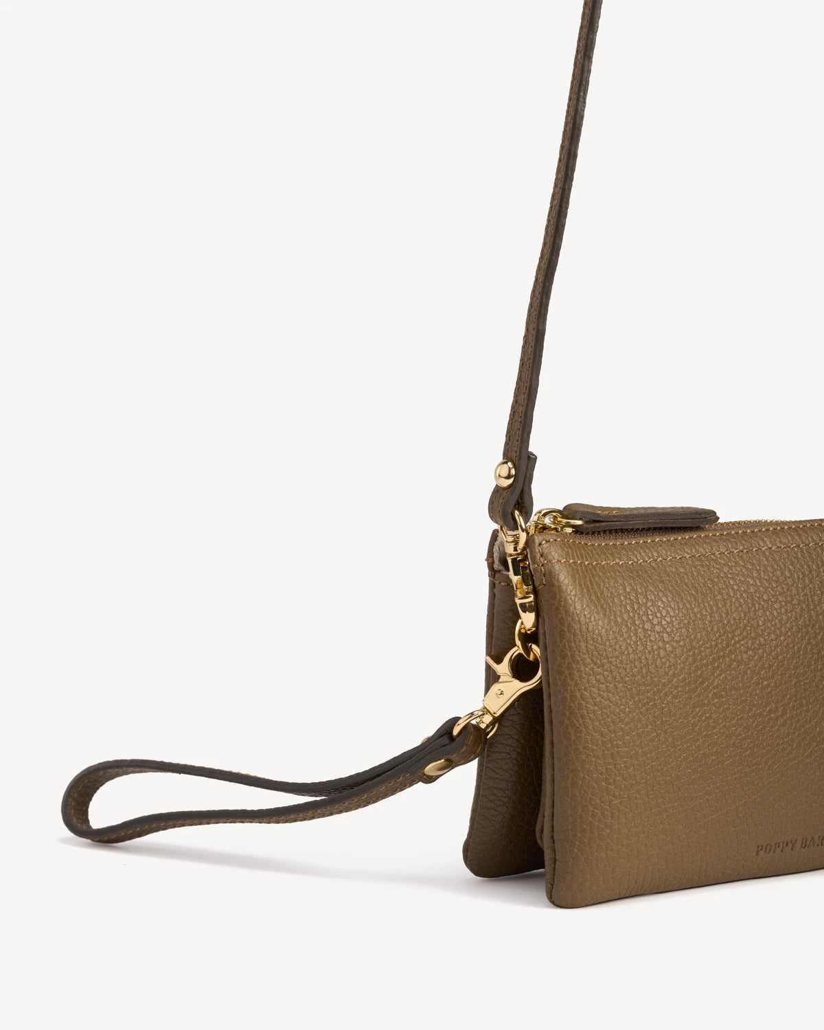 Side profile of the pebbled-leather wristlet showing zipper and wrist strap. The 3-in-1 Wristlet Tapenade.